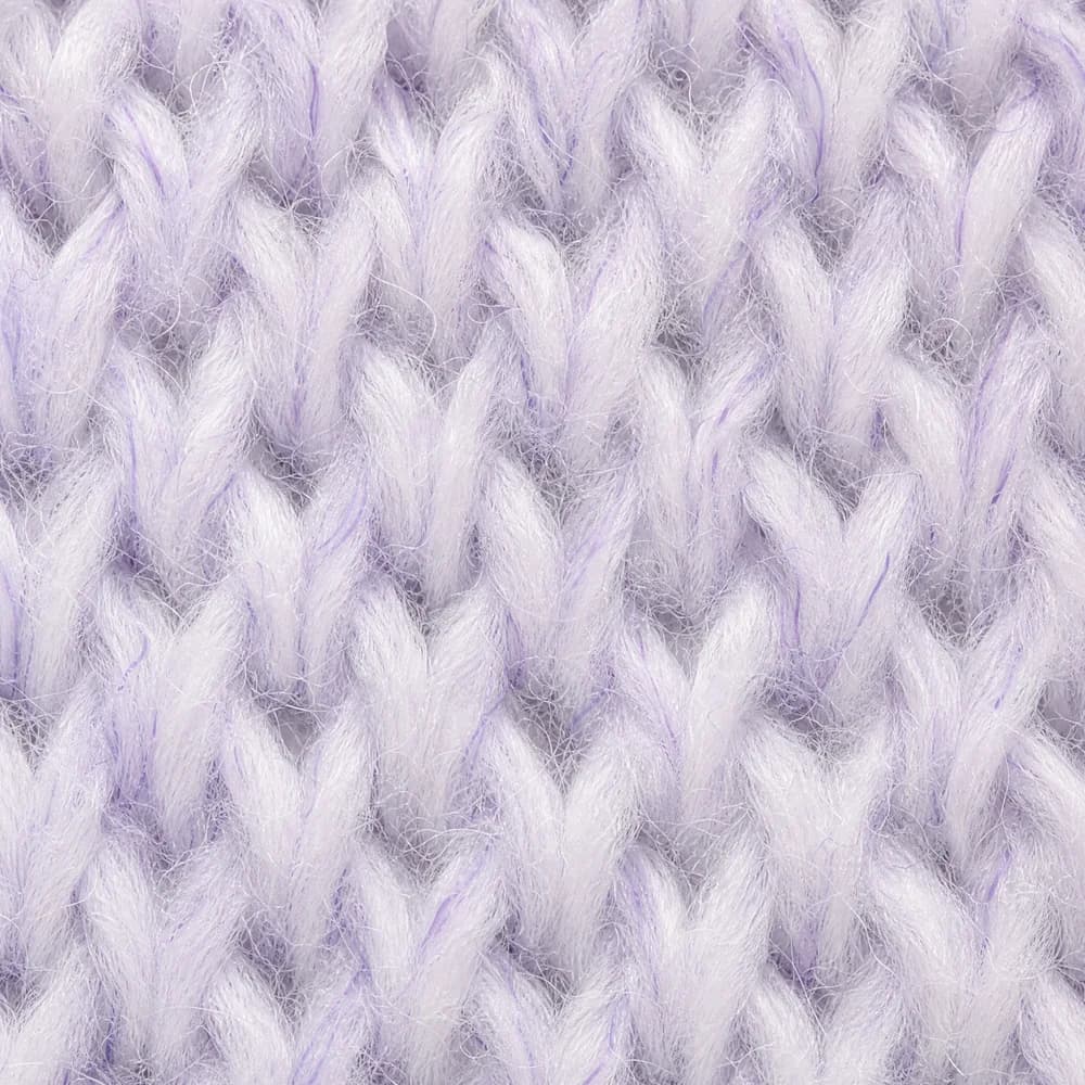 Extreme macro of white knitted cotton loops with faint violet-tinted fibres woven through the white yarn.