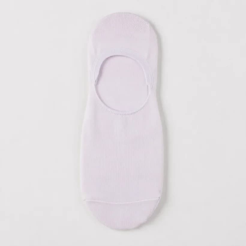 A white trainer liner sock laid flat with a faint overall violet tint in the white.