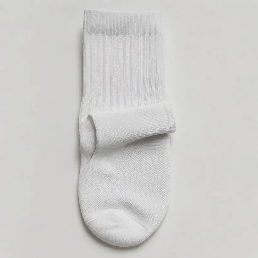 A white sports sock laid flat and folded once at the ankle, showing a tonal difference between thick and thin knit.